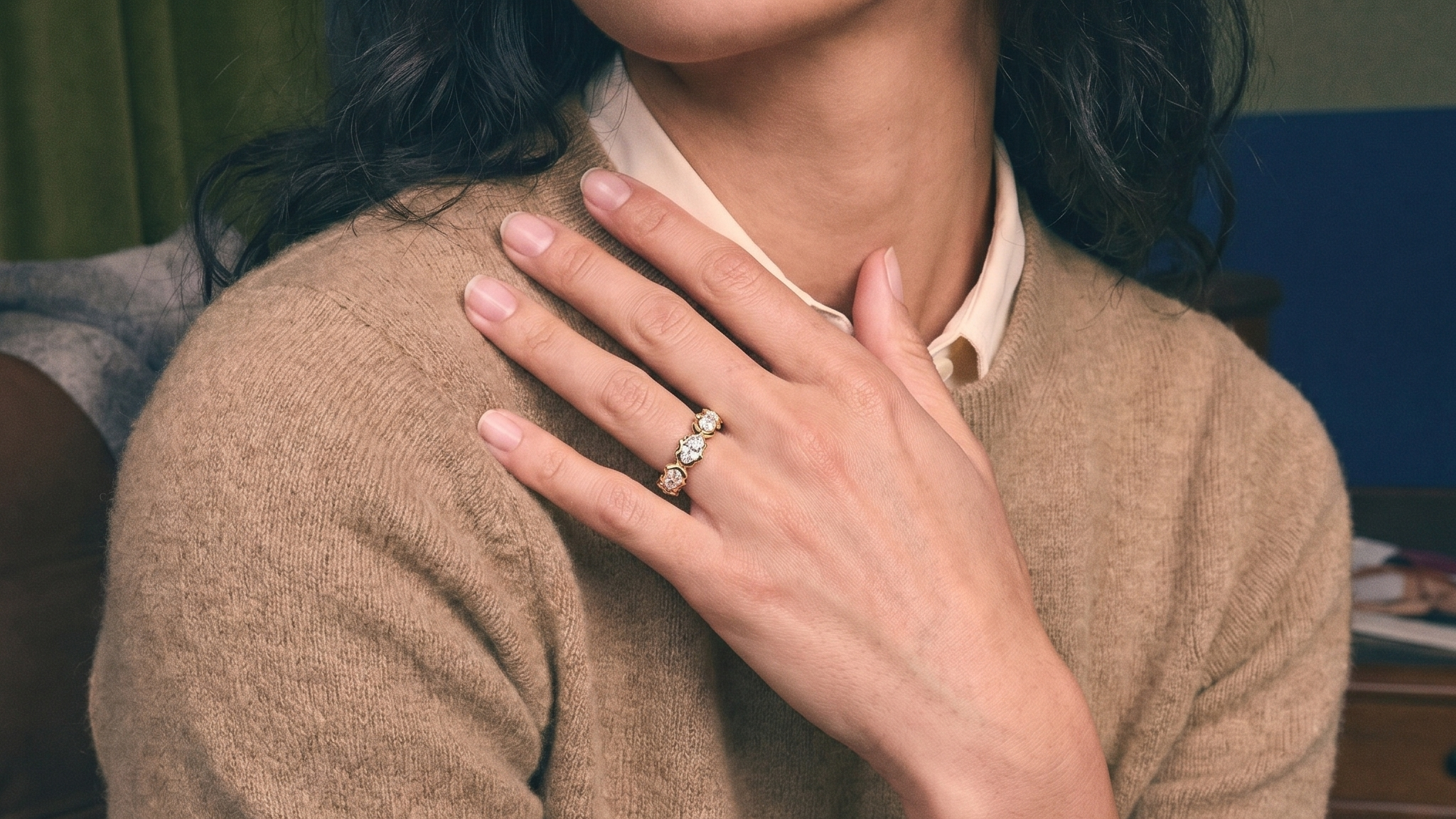 Hand wearing a custom lab grown diamond gold eternity wedding band, bridal styling on ivory silk