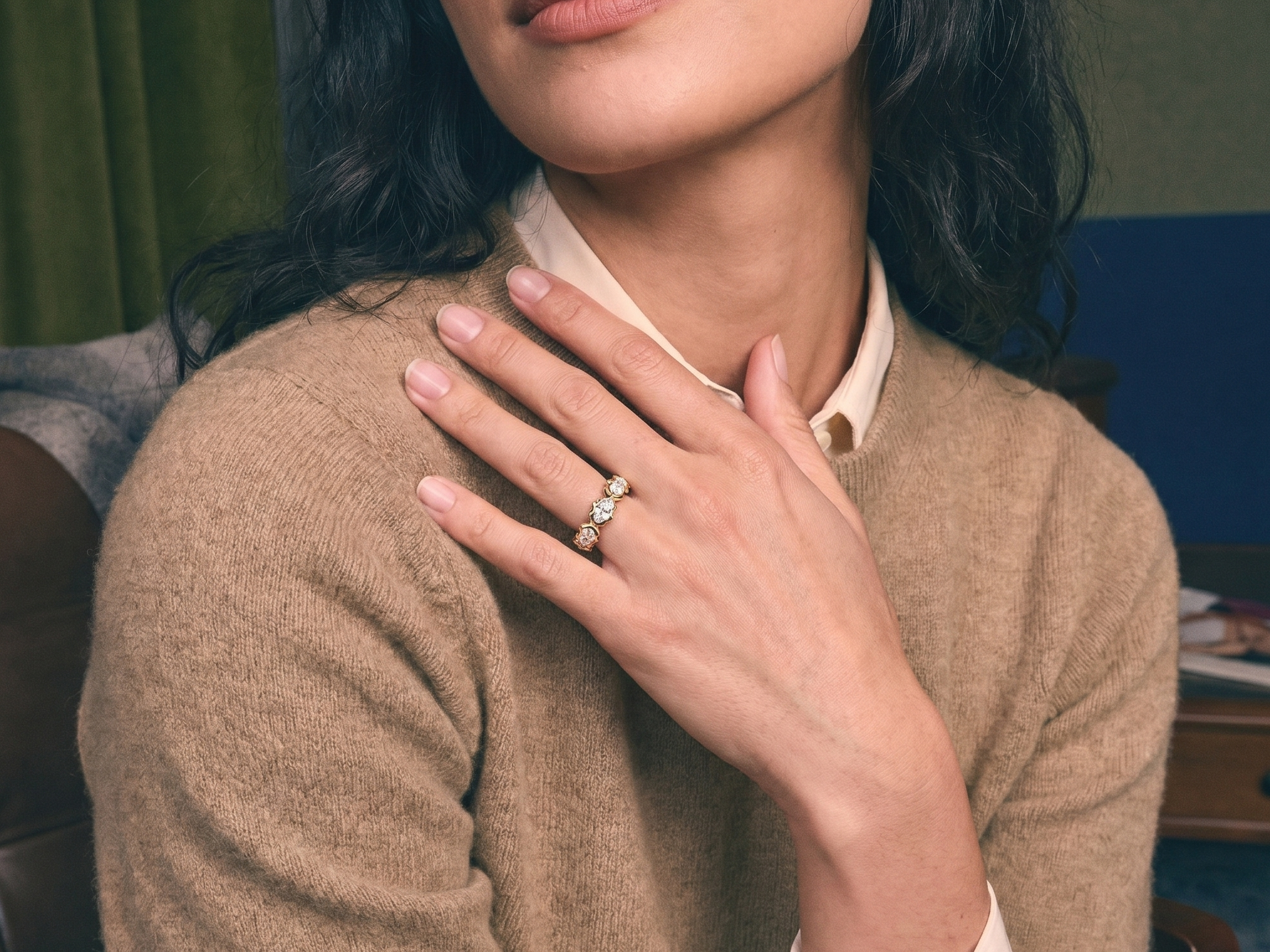 Hand wearing a custom lab grown diamond gold eternity wedding band, bridal styling on ivory silk