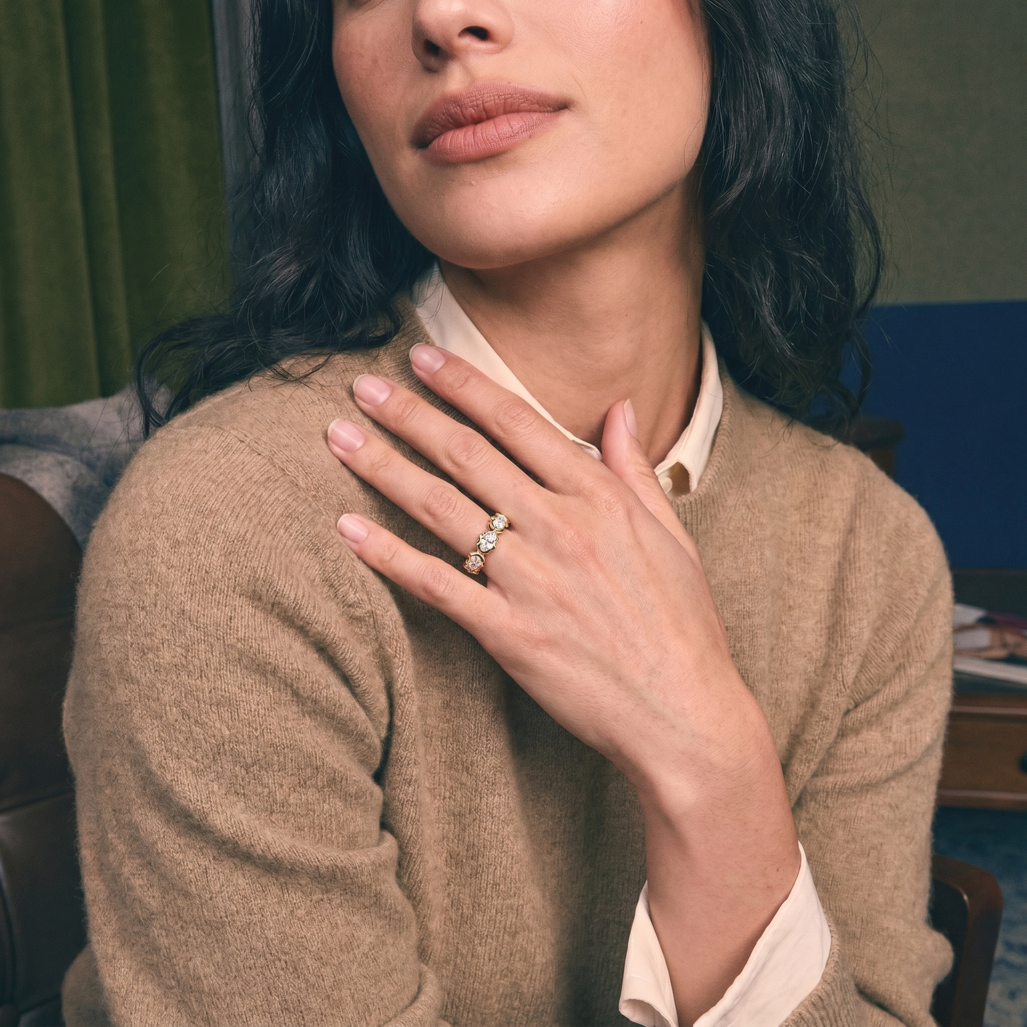 Hand wearing a custom lab grown diamond gold eternity wedding band, bridal styling on ivory silk