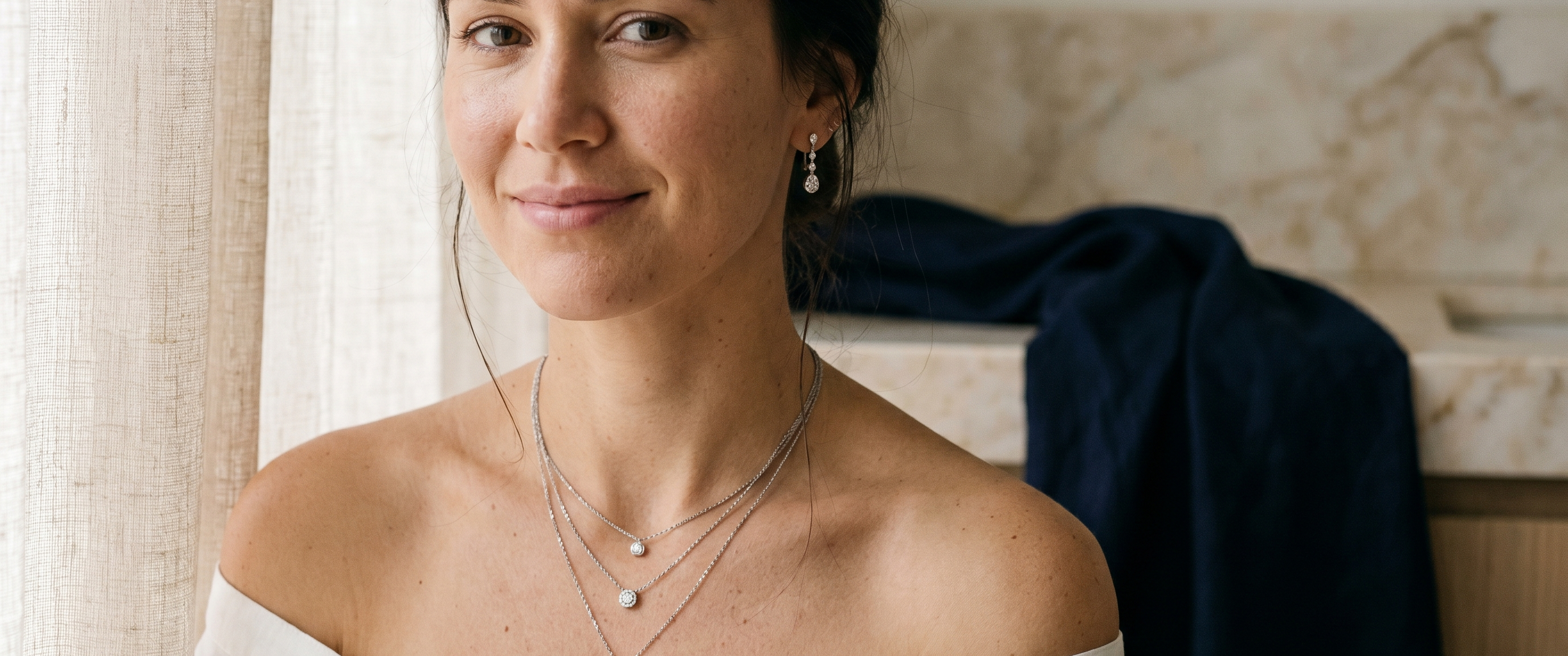 Woman layering lab grown diamond necklaces and earrings for summer styling