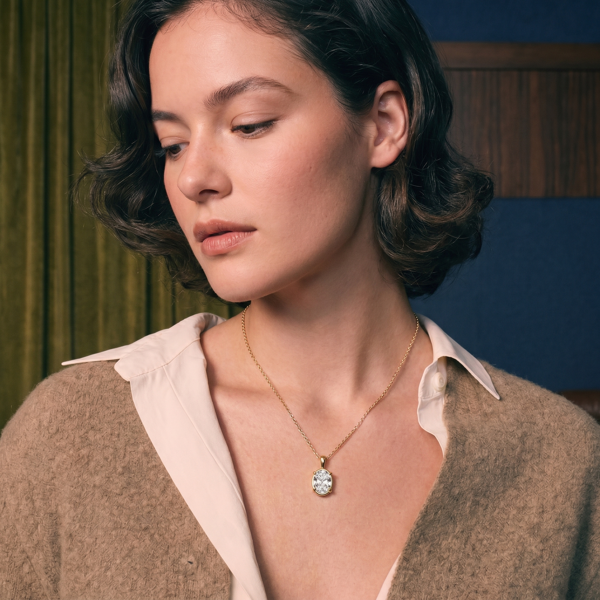 Oval lab-grown diamond solitaire pendant in gold on skin, illustrating diamond carat size and face-up scale